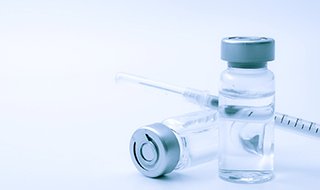 Two vials of Dysport next to syringe