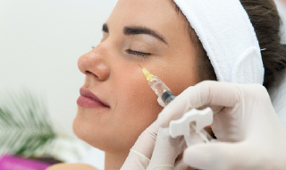 A young woman receiving Juvéderm® treatment while visiting her skincare specialist