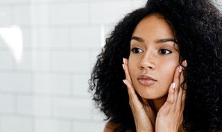 Woman examining her face