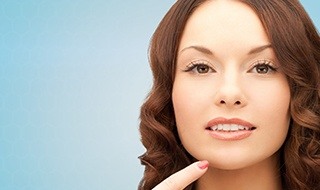 Woman pointing to her chin