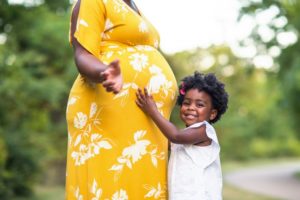 parent with a child holding their belly