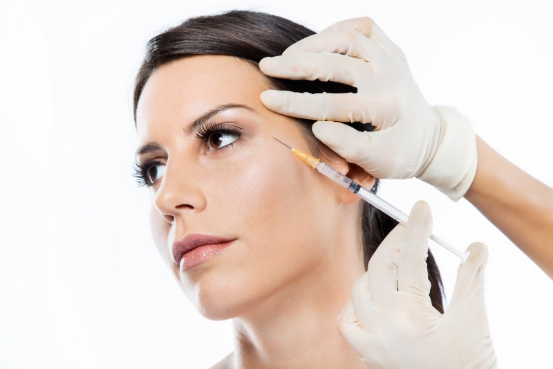 a woman receiving a Botox treatment by a skilled skin care specialist 