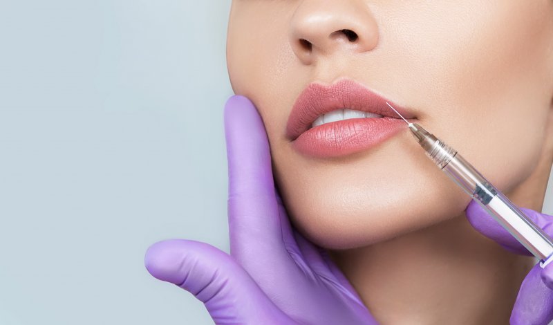 a woman receiving lip fillers