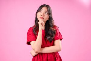 Woman wearing curious expression, thinking about BOTOX side effects