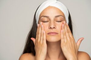 Woman gently massaging her own face 